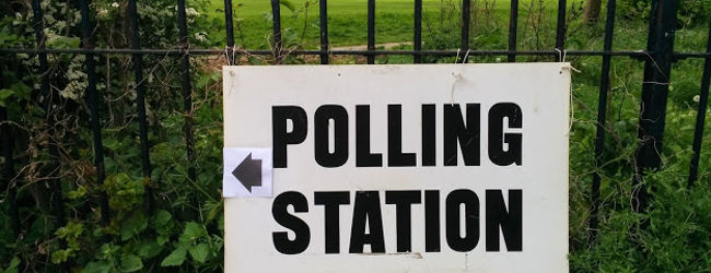 Polling station sign near Hampstead Heath, May 2015, by Bondegezou